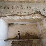 Non vi � traccia di arredamento, mentre una bottiglia di birra vuota e inguardabili scritte testimoniano l'incivilt� di alcuni visitatori